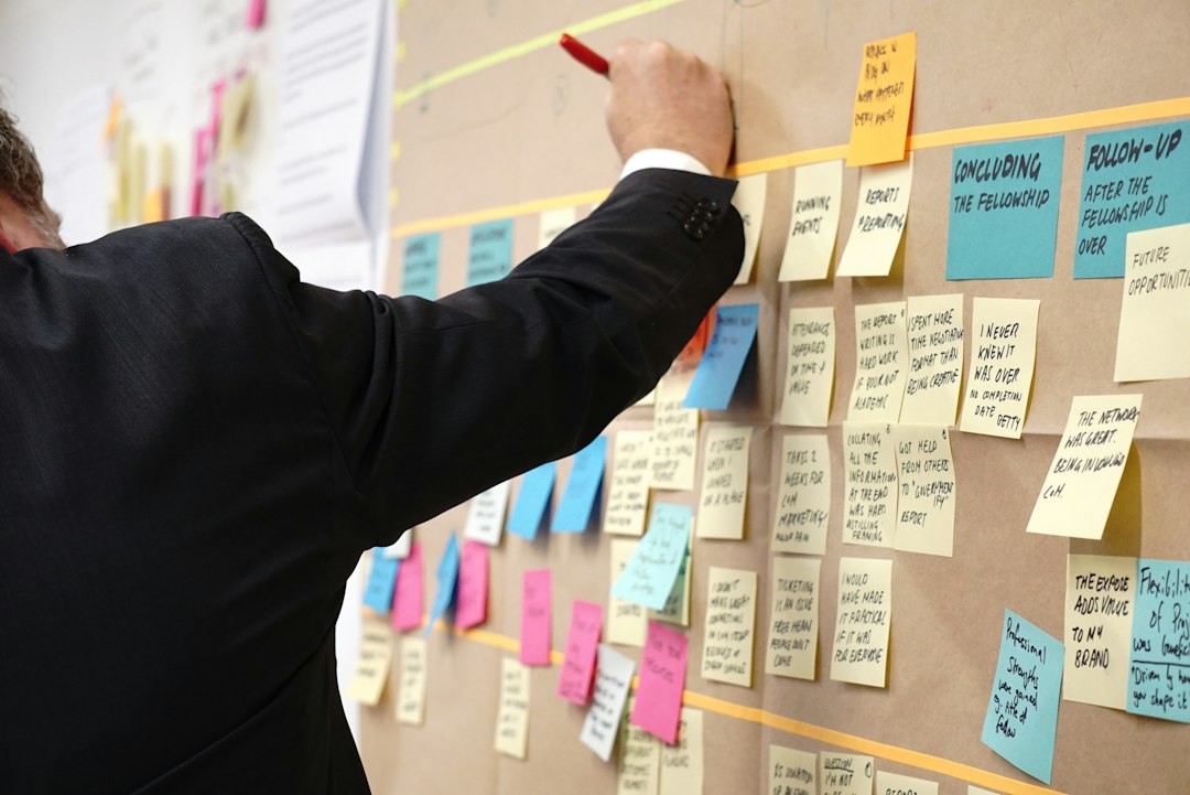 Sticky notes on a corkboard from a process-mapping workshop